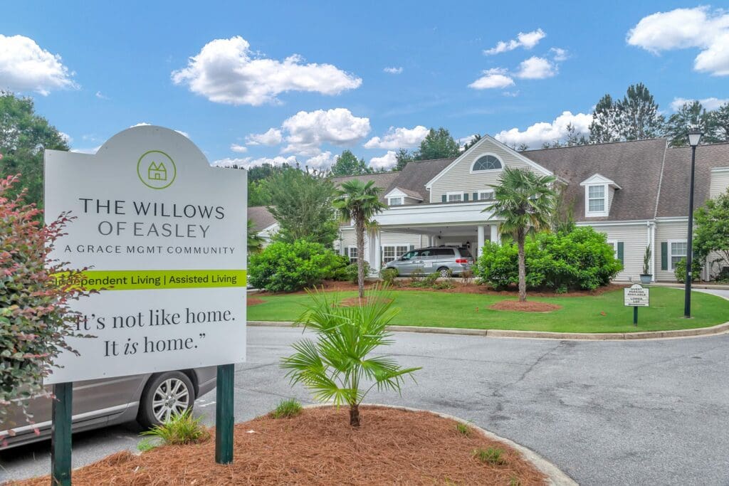 The Willows of Easley sign in the main driveway, leading to the building.