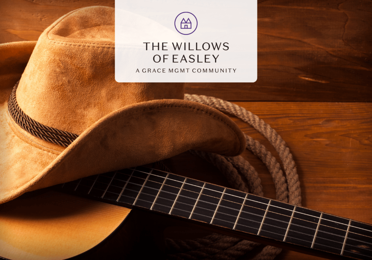Cowboy hat resting on an acoustic guitar with a rope, wooden backdrop, and a white overlay reading 'The Willows of Easley' and 'A Grace MGMT Community'.